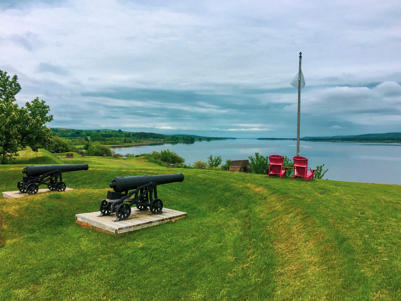 Ready, Aim, Fire... Two cannons pointed towards 2 red chairs Annapolis Royal, Nova Scotia. Taken on June 4th, 2016.